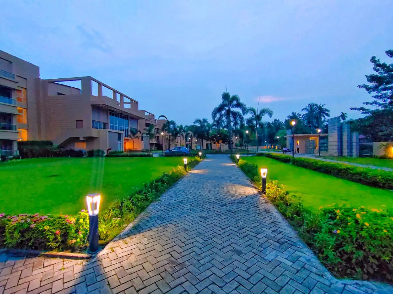 Lantern-lit front lawn pathway at dusk